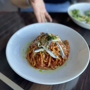 a plate of spaghetti with anchovies