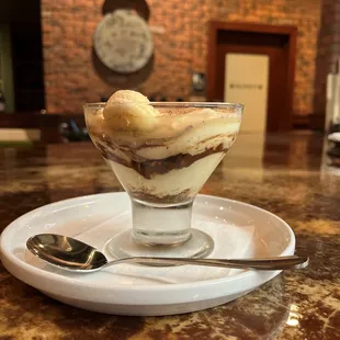 a dessert in a glass with a spoon