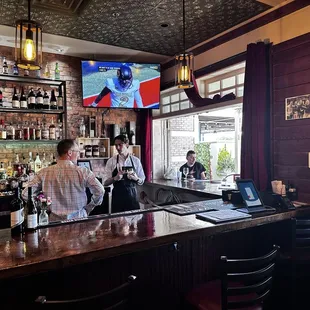 People seated at the outside bar looking in