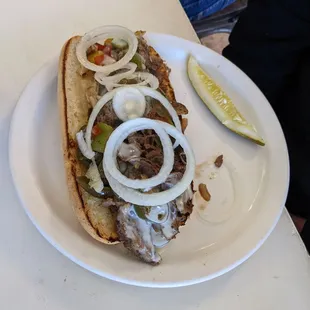 a sandwich with onions and meat
