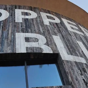 a wooden building with a sign that says copper blues