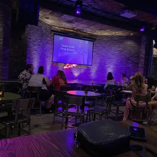 people sitting at tables in a restaurant