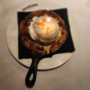 a skillet with a scoop of ice cream on top