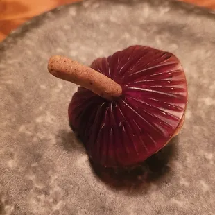 Tart of Japanese Eggplant with a reduction of red wine and pomegranate with a sesame cracker stem.