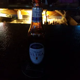 a beer bottle on a bar counter