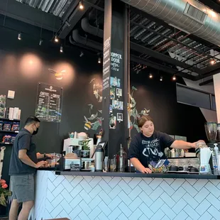 a man standing behind the counter