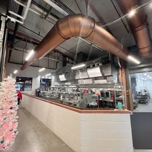 a kitchen with a christmas tree in the foreground