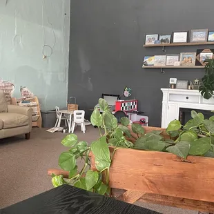 Cozy corner with couch, fireplace, and kids spot