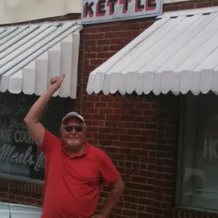 a man in a red shirt and white shorts