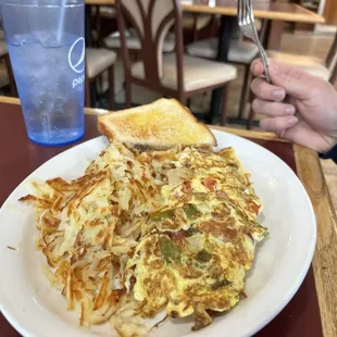 a person holding a fork and a plate of food