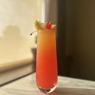 a glass of orange juice on a table