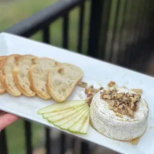 Baked Brie with Granny Smith apples, candied walnuts and honey served with baguette.