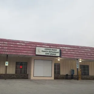 In a strip mall, do I see a phone booth