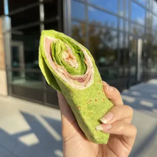 a hand holding a green wrap
