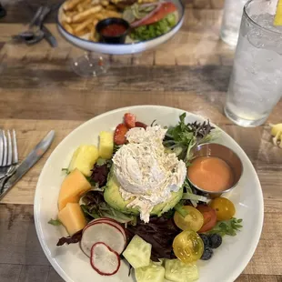 Top: Smash burger  Bottom:Chicken salad avocado boat with fresh greens&amp; berries