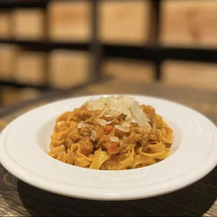 a plate of pasta with meat and cheese