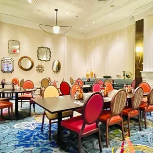 a dining room with colorful chairs