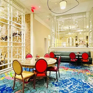 a dining room with a colorful carpet