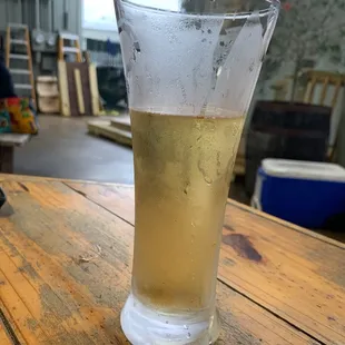 a glass of beer on a wooden table