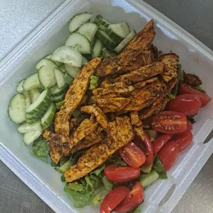 a salad in a styrofoam container