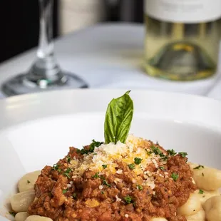 a plate of pasta and a glass of wine