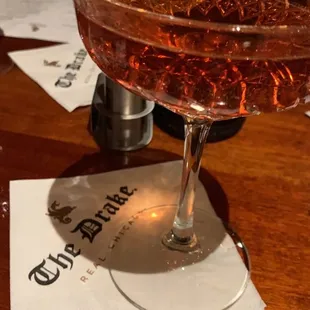 a cocktail with a slice of lemon