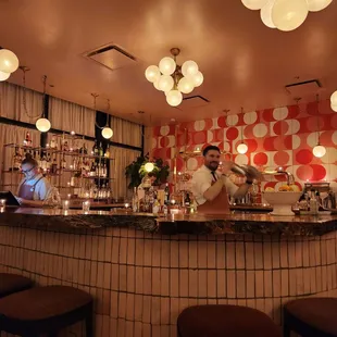 a man behind the bar at a restaurant