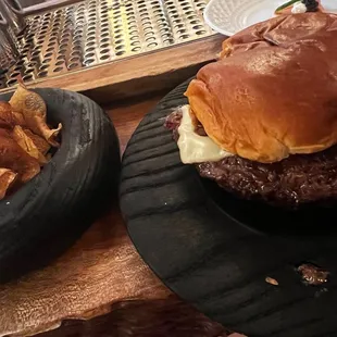 a burger and potato chips on a plate