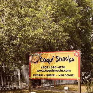 a sign in front of a fence