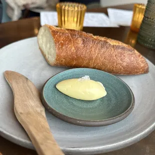 a loaf of bread and butter on a plate