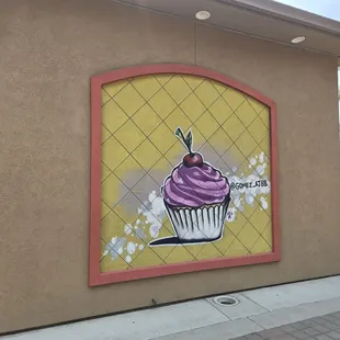 Look for the cupcakes on the wall. This place can be easily overlooked.