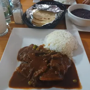 a plate of food with rice and beans