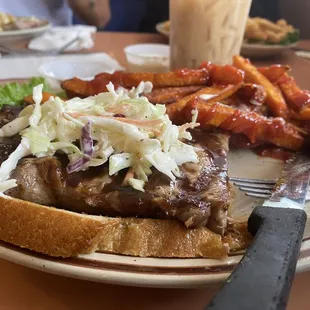 Open faced Steak sandwich with a side of Cole slaw and sweet potato fries. Very Yummy.