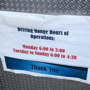 Sign on driving range ball machine.