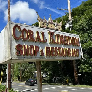 the sign for coral kingdom surf restaurant