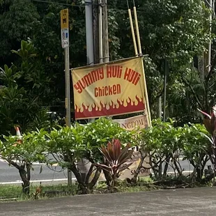 a man riding a horse in front of a sign
