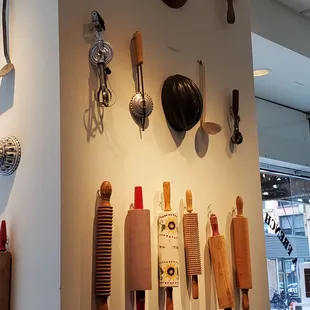 a variety of kitchen utensils on a wall