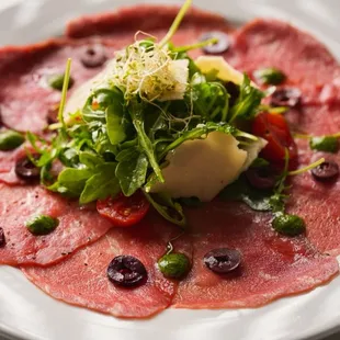 a plate of food with meat and vegetables