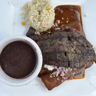 Enchiladas mole poblanos with a charred steak on top!