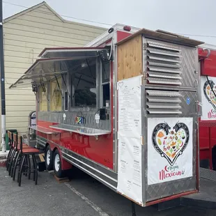 Outside of food truck, showing 5-6 barstools
