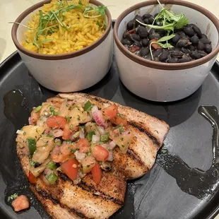 Blackened mahi with pineapple salsa, saffron rice, and seasoned black beans