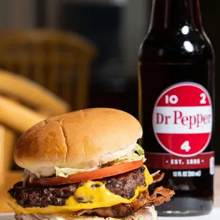 a burger and a bottle of dr pepper