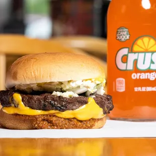 a closeup of a burger and a soda