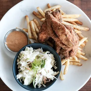 a plate of fried chicken, fries and coleslaw
