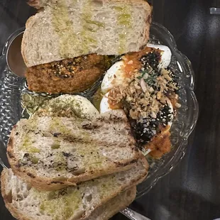 Farmers cheese with za'atar, garlic, honey, carrot muhammara, jammy eggs with harissa and furikake.