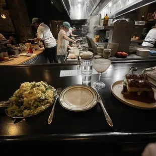 chefs in a restaurant kitchen preparing food