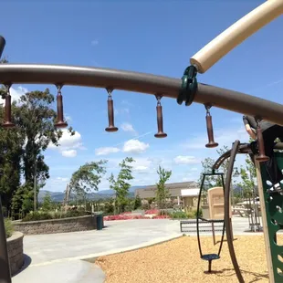 Vine style monkey bar feature in big kids area. Each hanging thing is semi soft and swings.