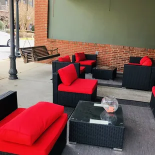 a patio with red cushions