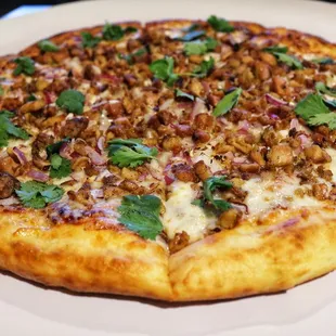 a whole pizza on a plate