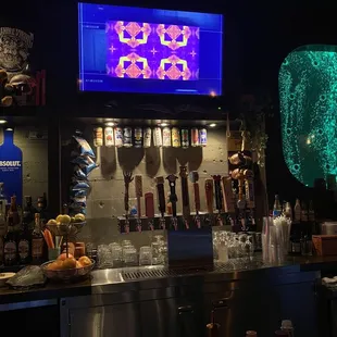 a bar with a neon sign above it